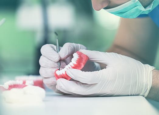 Dental team member completing a denture repair