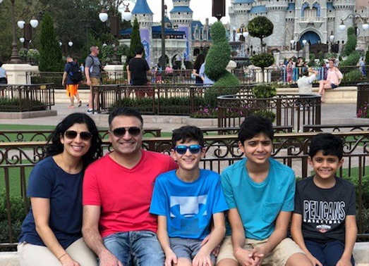 Doctor Patel and his family at a theme park