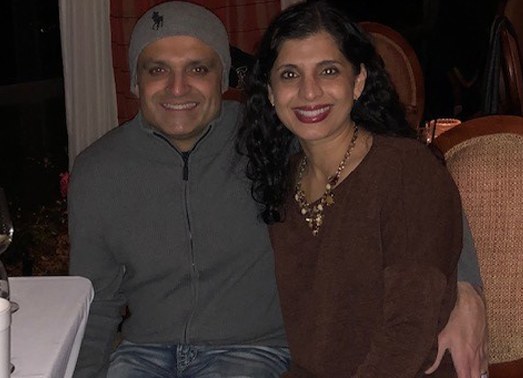 Doctor Patel and his wife smiling on vacation