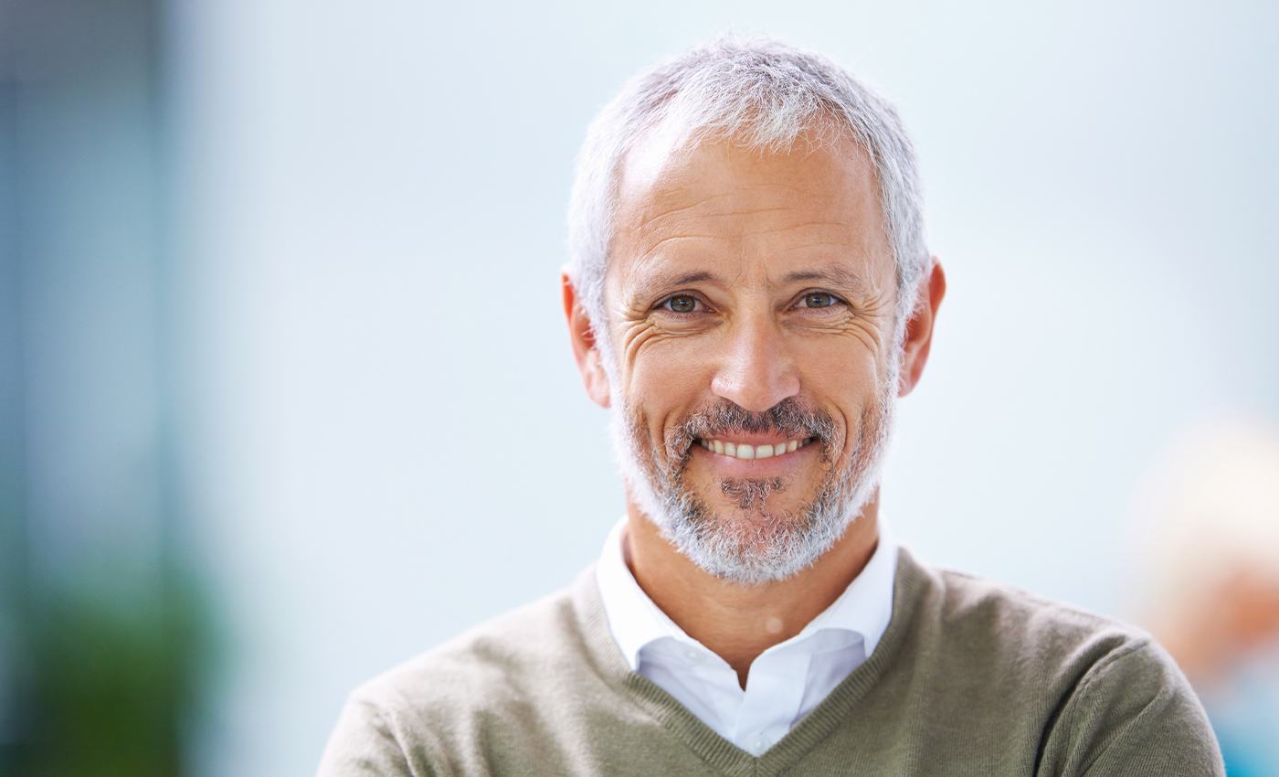 Older man with denture smiling