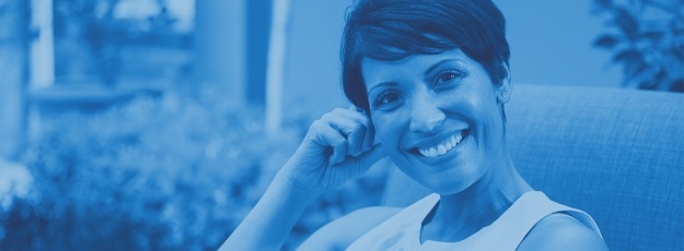 Woman smiling during denture exam and consultation