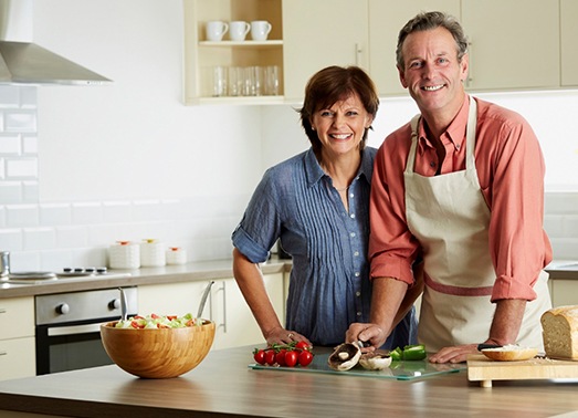 An older couple preparing a meal.